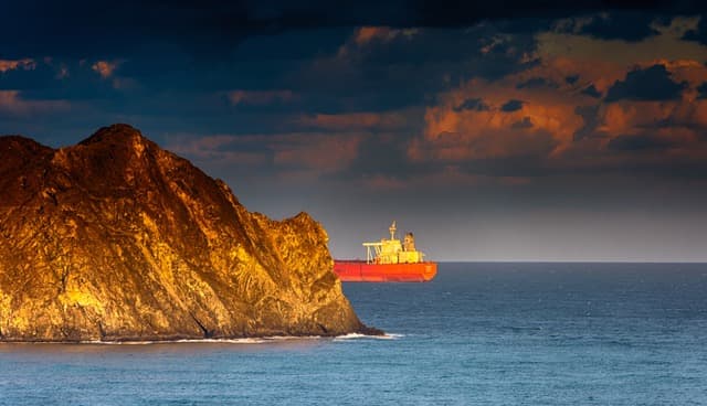Ship near golden cliffs